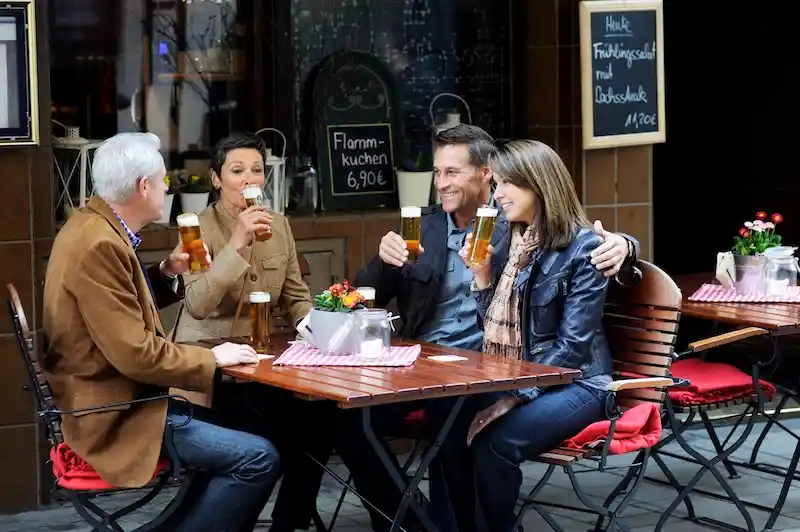Viking river cruise guests enjoying kolsch in Cologne, Germany