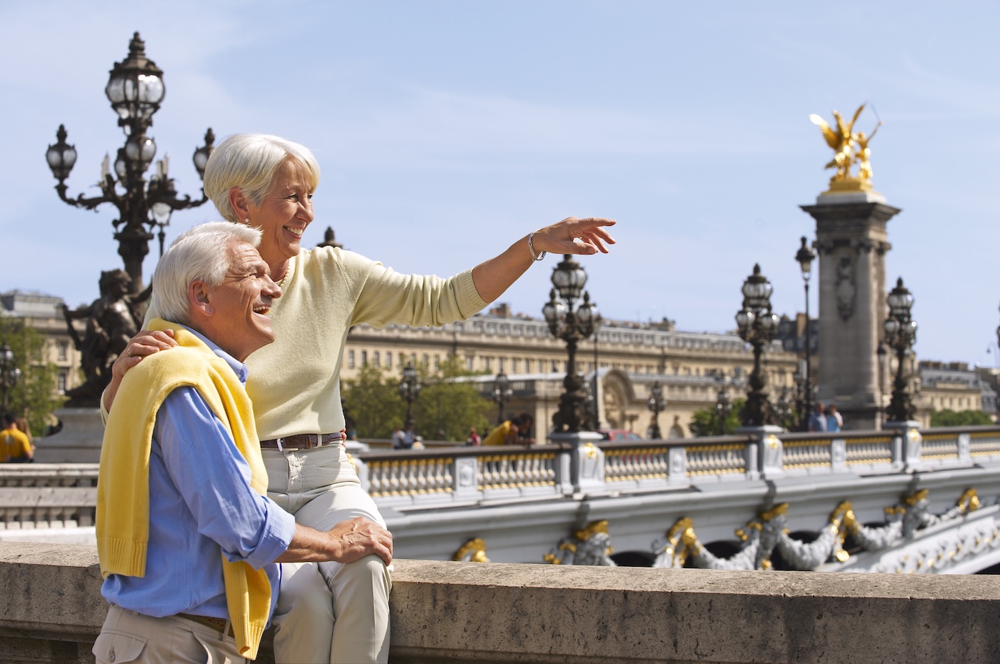 A couple at the Seine River Bridge looking out onto the sites of Paris.